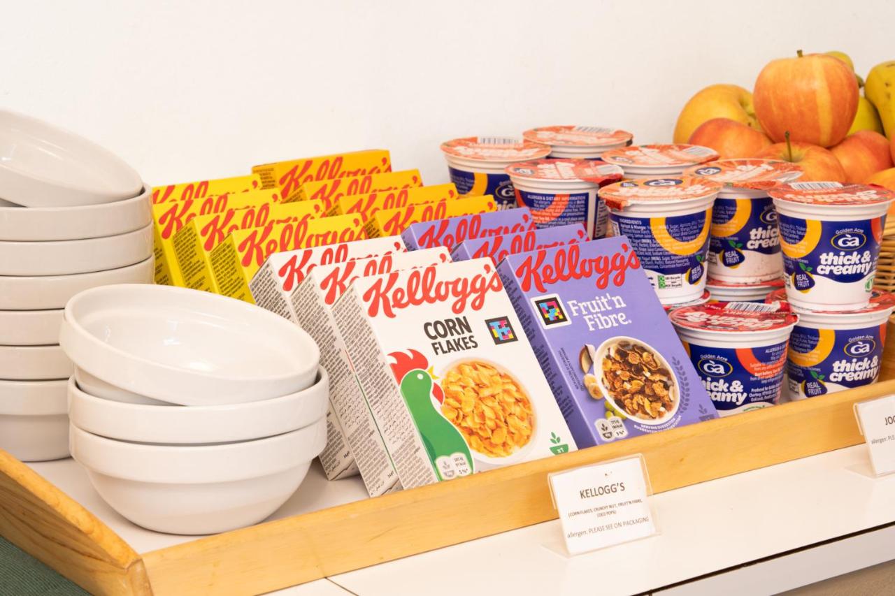 a shelf with bowls and plates and some food at 72QT in London